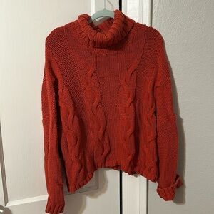red orange cable knit turtleneck